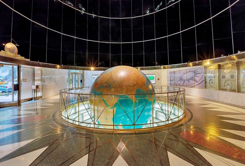 an office building with a large globe in the middle of the room